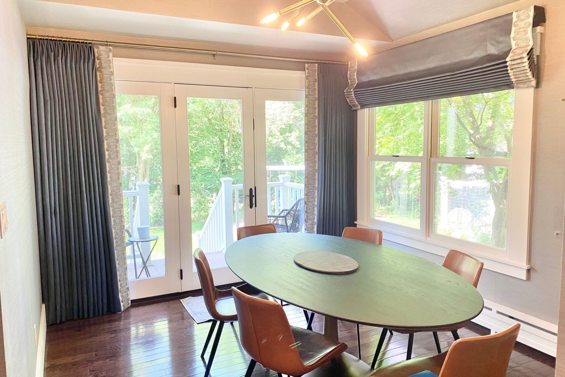 Custom drapes and motorized shades in Reverie Drama color. Kitchen dining nook